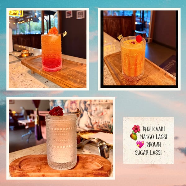 Three vibrant lassi drinks, two mango and one brown sugar, on wooden trays in a restaurant setting.