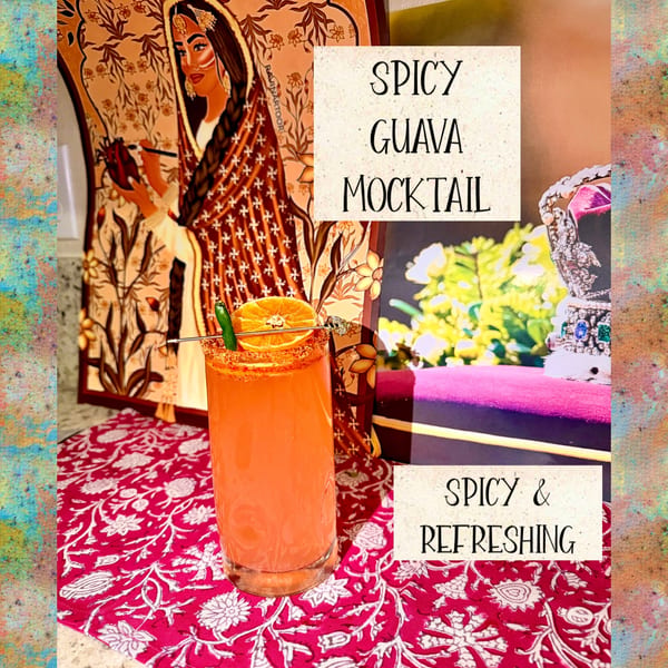 Spicy Guava Mocktail garnished with orange and chili, on a red floral placemat.